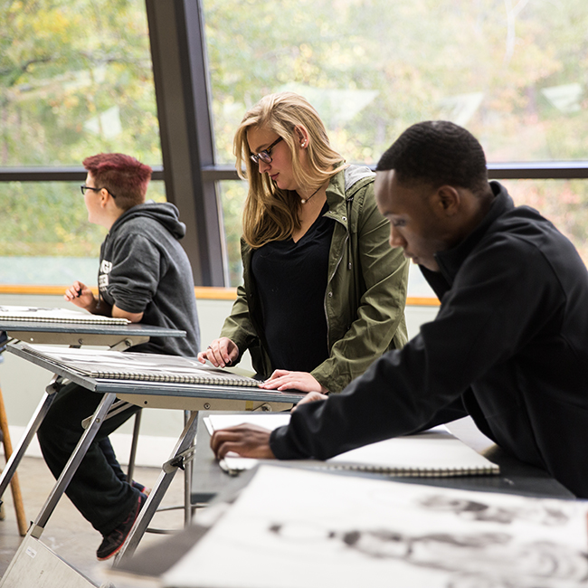 Students doing charcoal drawings in Drawing studio.