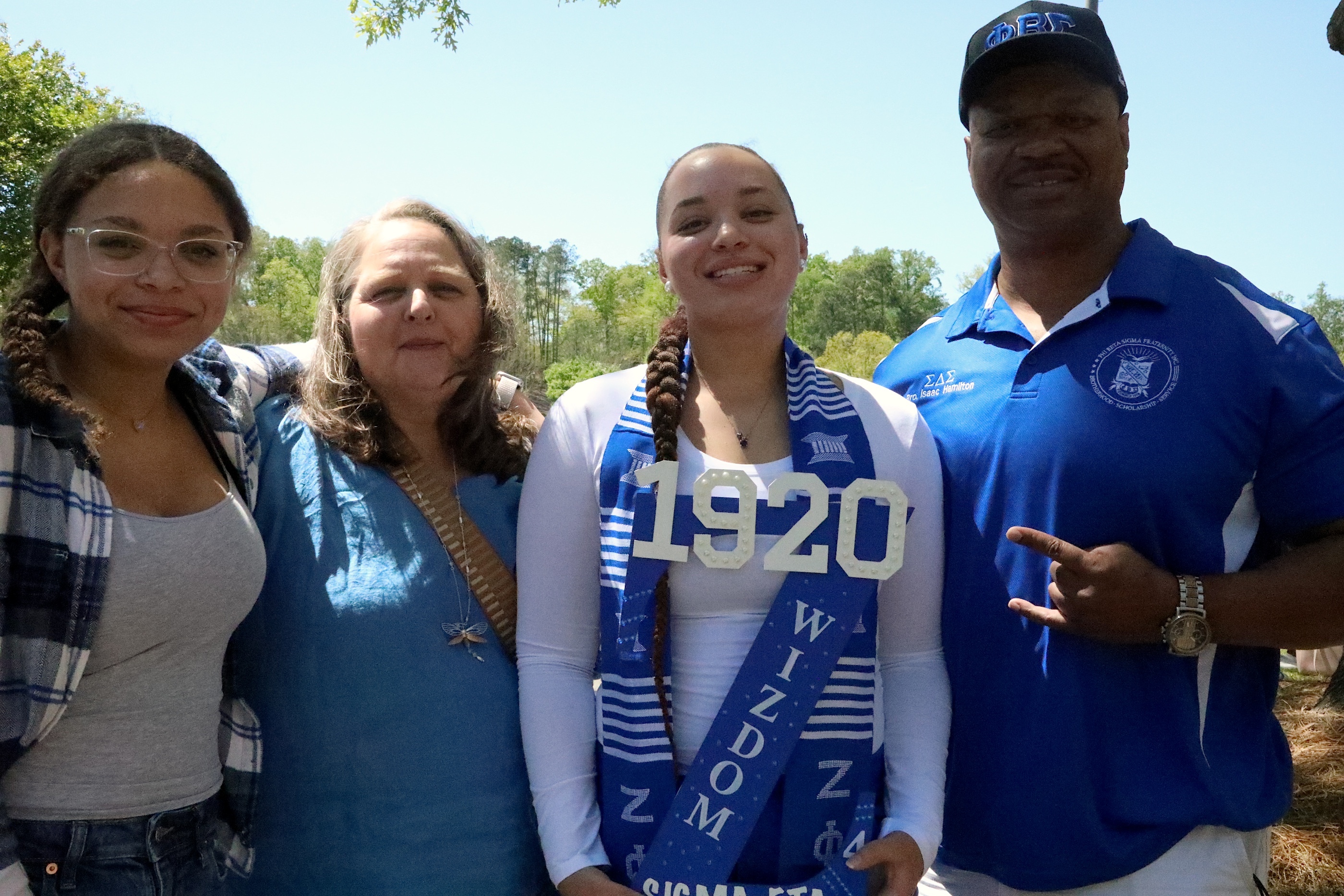 A student and her parents pose for a photo after a college event