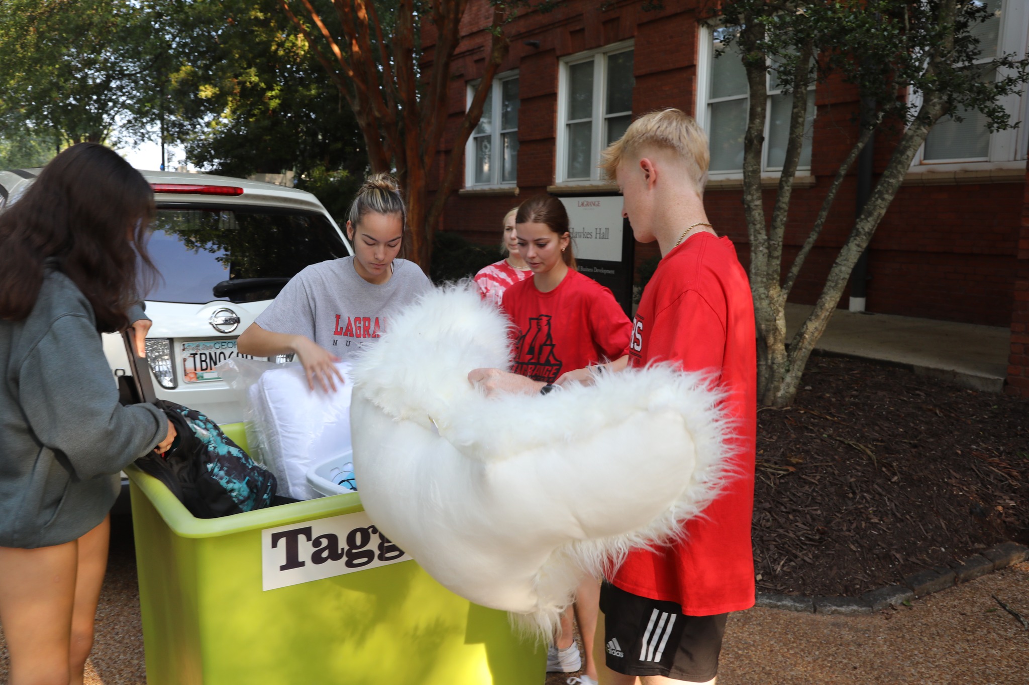 Students carrying their possessions into Hawkes Hall on move-in day