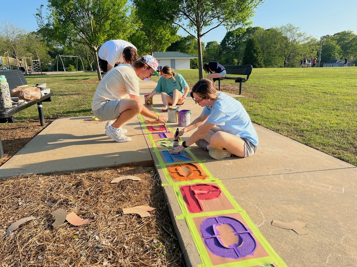 Students painting local playground